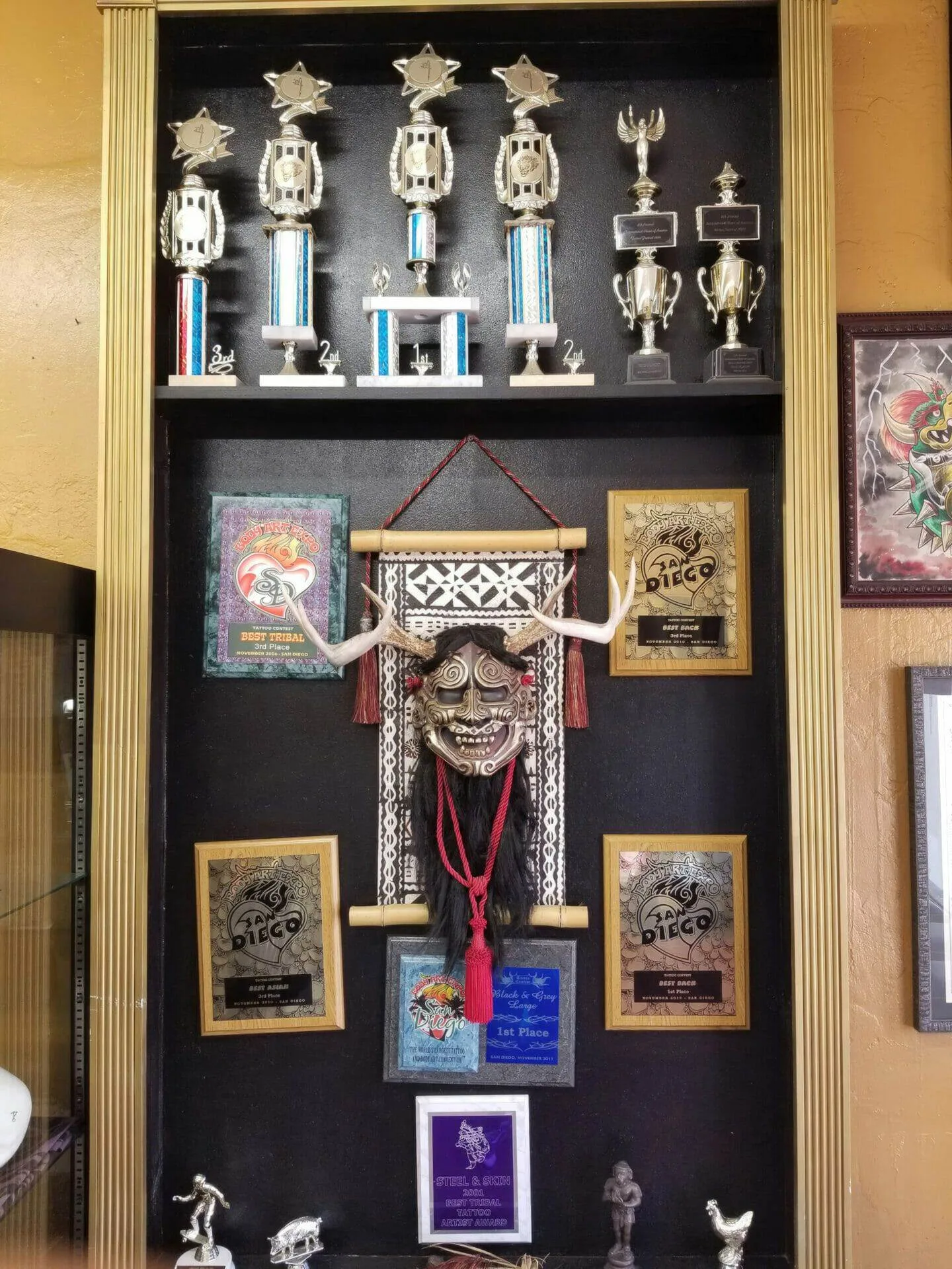 Award trophies at Funhouse Tattoo